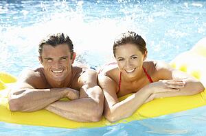 Young couple having fun in pool