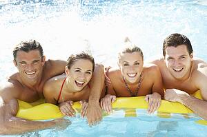 Group of Young friends having fun in pool