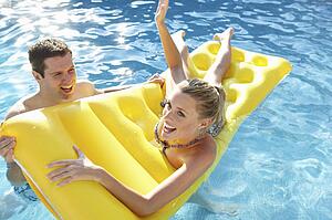Young couple having fun in pool