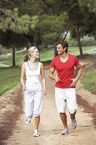 Young couple running in park