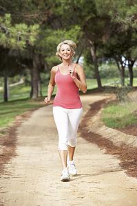 Senior woman running in park