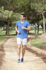 Young man running in park