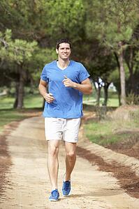 Young man running in park