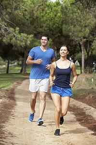 Young couple running in park