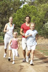 Family running on path in park