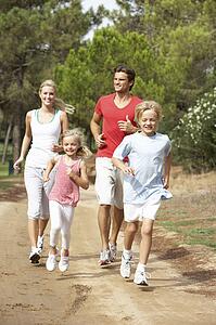 Family running on path in park