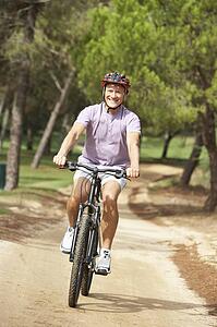 Senior man enjoying bike ride in park
