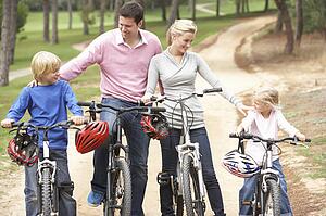 Family enjoying bike ride in park