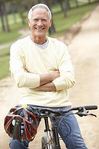 Senior man riding bicycle in park