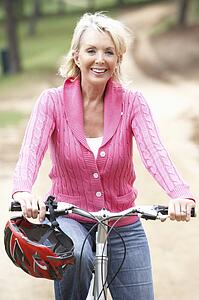 Senior woman riding bicycle in park