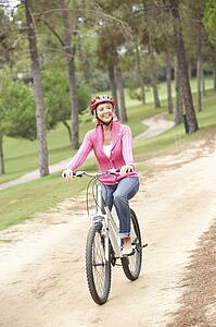 Senior woman riding bicycle in park