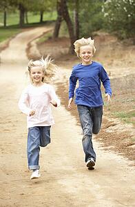 Two Children running in park