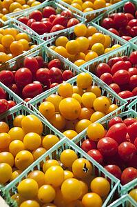 Yellow And Red Cherry Tomatoes In Small Baskets