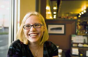 young woman smiling in a cafe