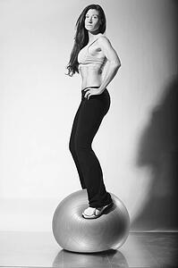 a woman in workout wear standing on an exercise ball; troutdale, oregon, united states of america