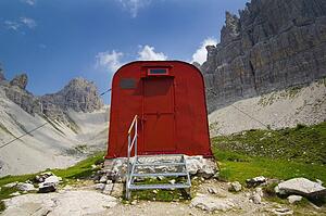red supply shed on a mountain trail; campanile, friuli venezia giulia, italy