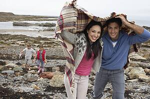 Family on beach with blankets