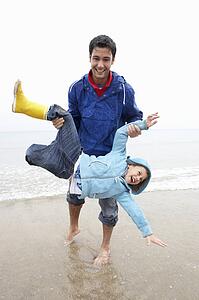 Happy father with son on beach