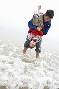 Happy father with son on beach