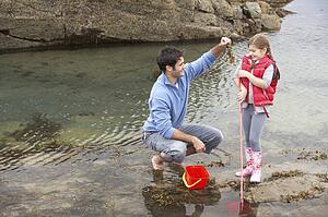 Father with daughter on beach