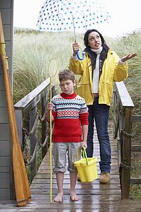 Sad woman and child with umbrella