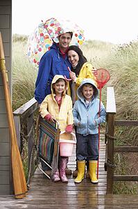 Family on beach with umbrella