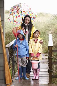 Sad mother and children on beach
