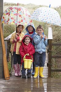 Children posing with umbrella