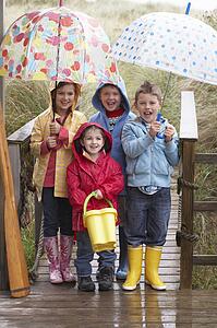 Children posing with umbrella