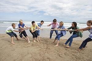Teenagers playing tug of war