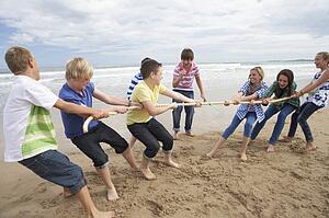 Teenagers playing tug of war