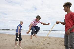 Teenagers playing skipping rope