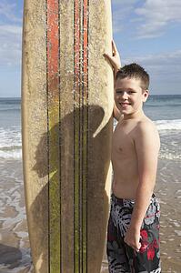 Teenage boy with surfboard