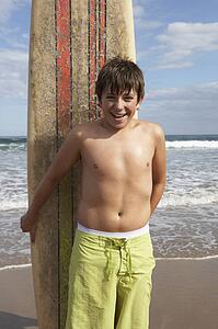 Teenage boy with surfboard