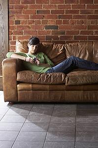 Young woman with phone on sofa
