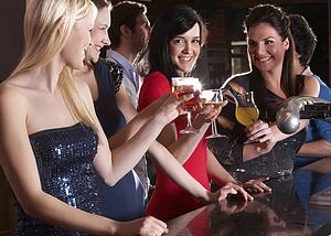 Young women drinking at bar