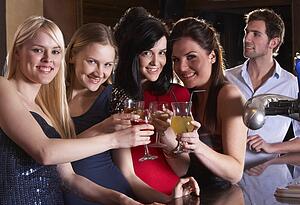 Young women drinking at bar