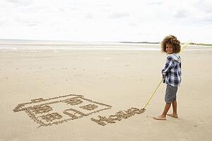 Boy drawing in sand