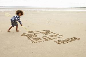 Boy drawing in sand