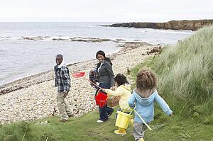 Family on beach collecting shells