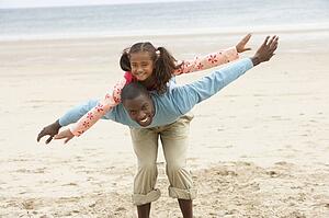 Father and daughter playing on beach