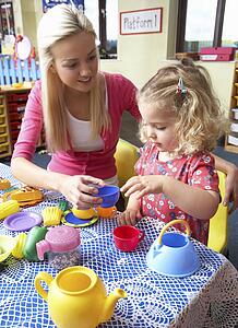 Young woman playing with girl