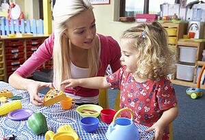 Young woman playing with girl