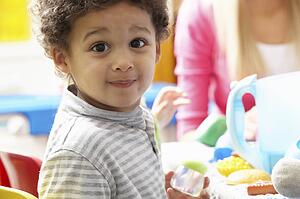 Boy playing with toys in nursery