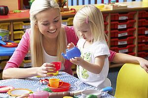 Young woman playing with girl