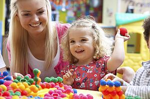 Young woman playing with girl