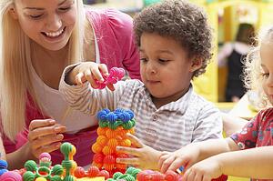 Young woman playing with boy