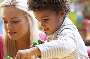 Young woman playing with boy