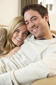Young couple sitting and relaxing on sofa