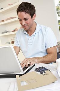 Young man working with laptop computer
